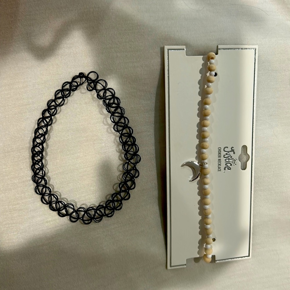 Cute set of choker necklaces. One with a moon on it and a plain black choker.